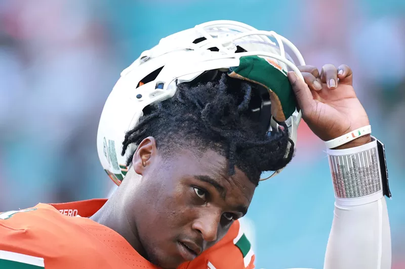 Image: Quarterback Cam Ward #1 of the Miami Hurricanes, looking determined with his helmet tilted back to show his face as he prepares to face Florida A&M Rattlers at Hard Rock Stadium on September 07, 2024