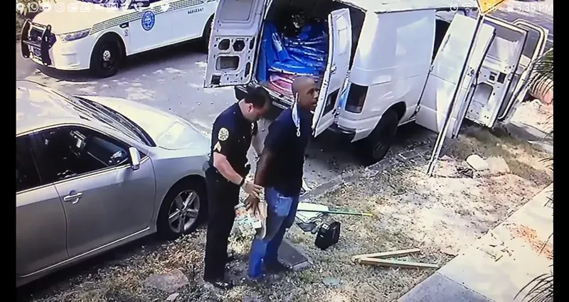 Image: Dr. Armen Henderson was handcuffed outside his home.