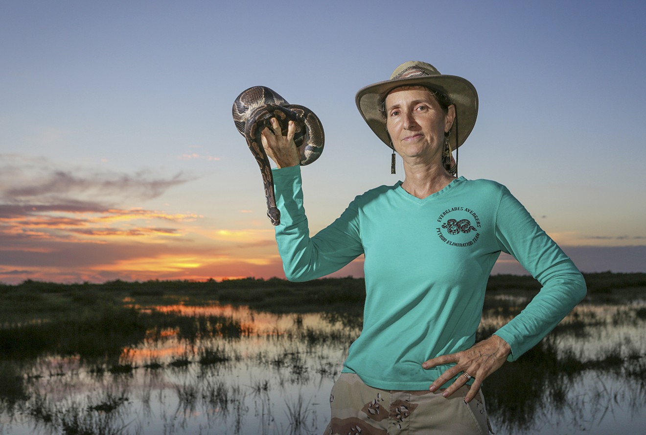 Donna Kalil holds a ball python she caught in the Everglades. She adopted the snake, naming him Benny.