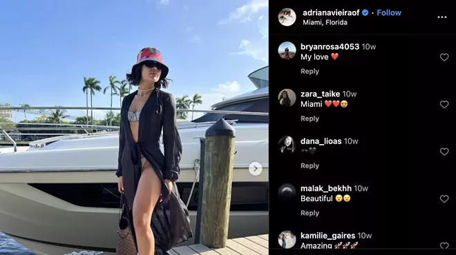 instagram screenshot showing a photo of a woman dressed in a bikini covered by a sheer robe, standing on a dock with a boat in the background