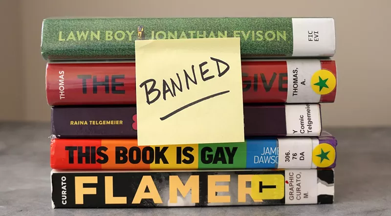 Image: A stack of books frequently found on banned book lists with a sticky note saying "banned"
