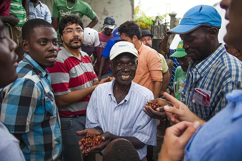Image: Haitian coffee farmers show off a new harvest.