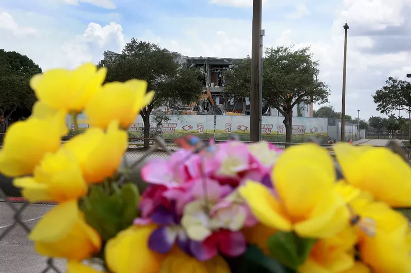 Image: June 17, 2024: Demolition crews continue to tear down a building at Marjory Stoneman Douglas High School in Parkland, FL, where 17 students and teachers were murdered in 2018. The building remained standing as a crime scene while Nikolas Cruz, who shot more than 30 people, faced prosecution. Cruz was sentenced in 2022 to life without parole.