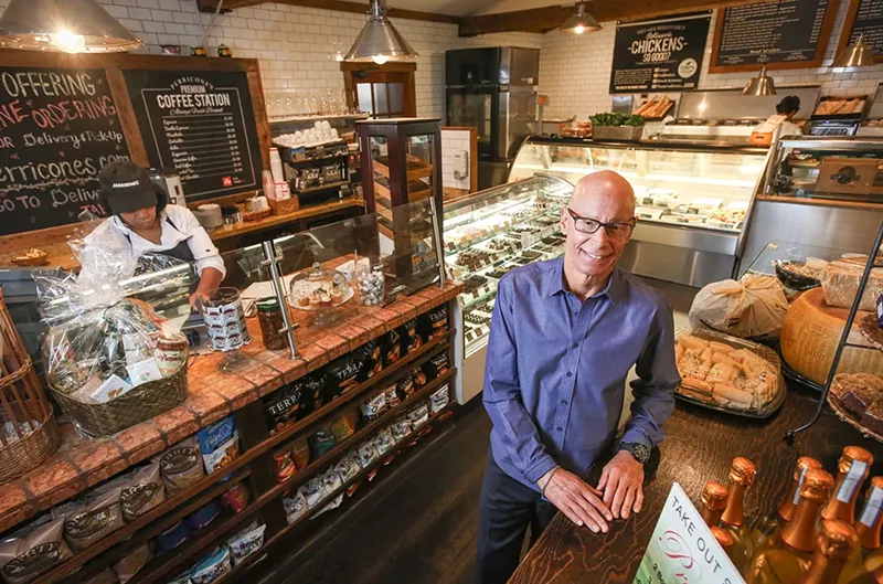 Image: A man posing at a restaurant.