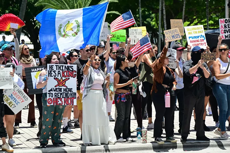 Image: Protesters in Miami rally against President Donald Trump policy decisions.