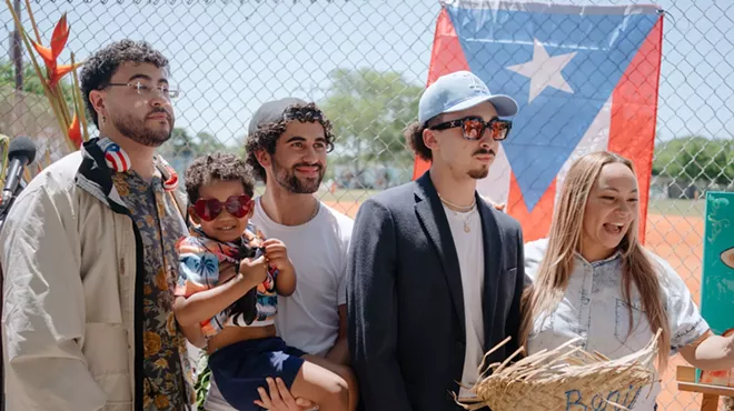 a group of men and a toddler dressed like Bad Bunny