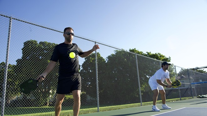 Two pickleball players standing on a court