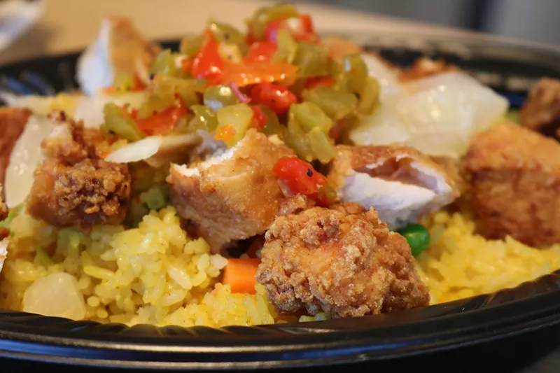 Image: TropiChop with yellow rice, vegetables, and crispy chicken bites.