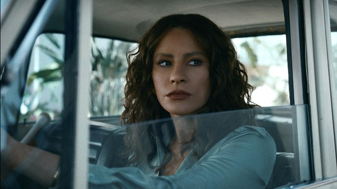 Still from Episode 1 of Griselda, showing Sofía Vergara as Griselda Blanco, at the wheel of a 1960s or '70s-era car.