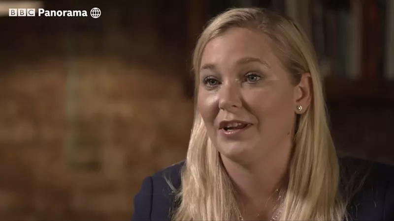 Image: a blond woman speaking during a filmed interview