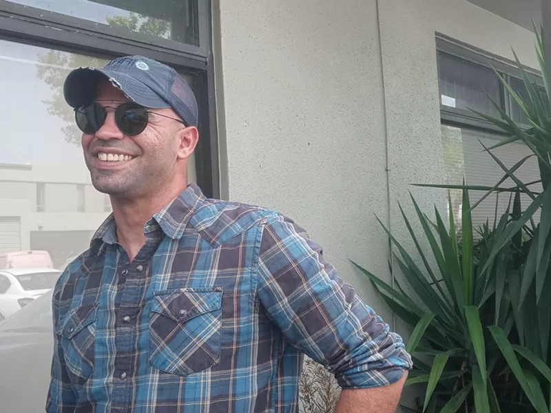 Image: Proud Boys chairman Enrique Tarrio smiles after being sentenced on August 23.