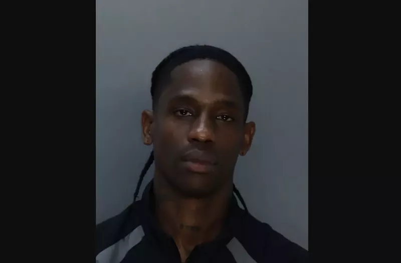 Image: Front-facing mug shot of rapper Travis Scott.