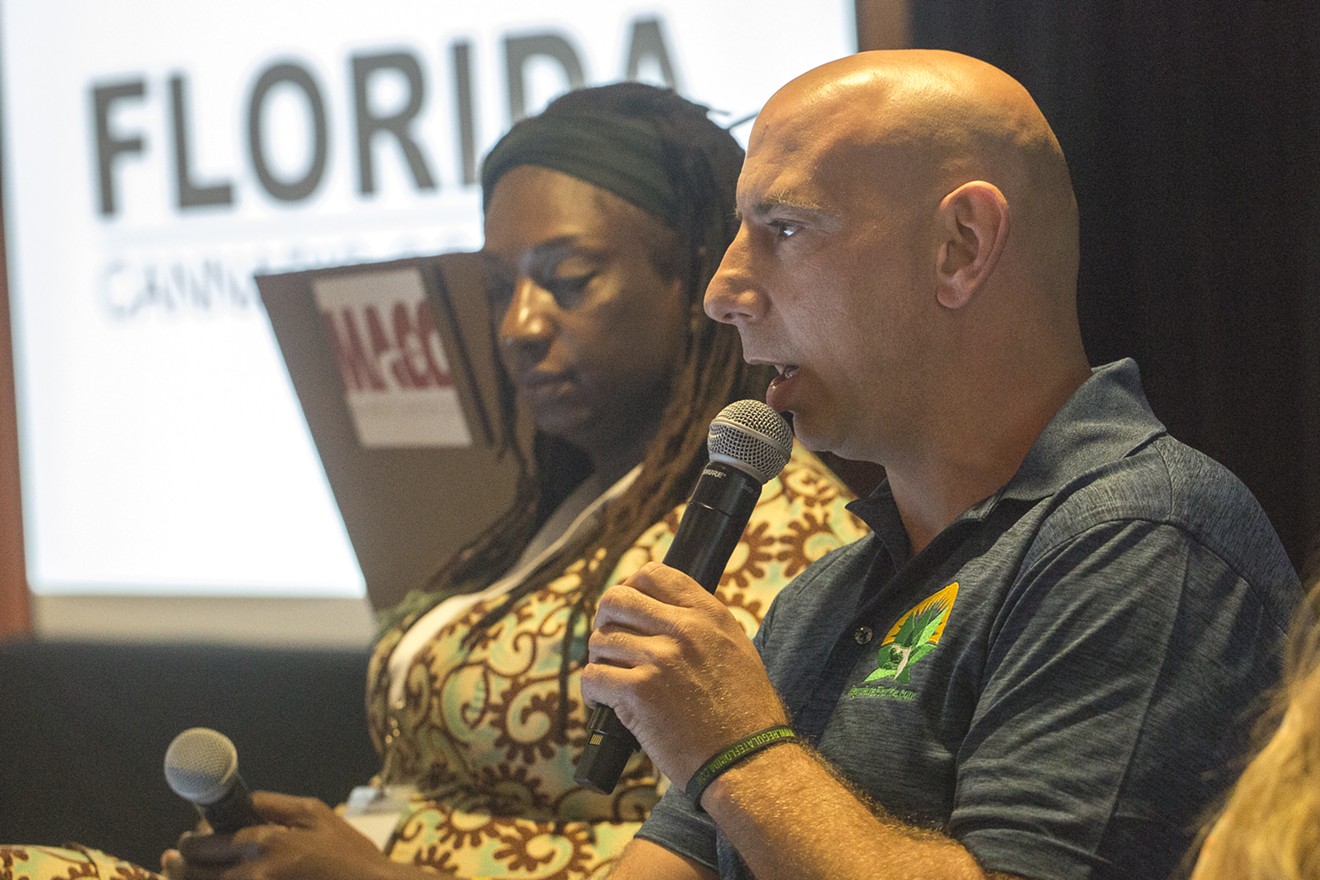Mike Minardi of Regulate Florida speaks on a panel during Saturday's Marijuana Hemp and Health Expo at the Doubletree Hotel by Miami International Airport. Cannabis attorney Scherill Murray Powell is in the background.