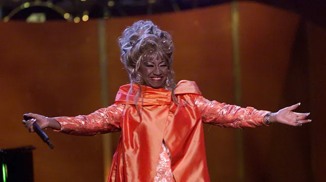 Celia Cruz on stage wearing a red dress