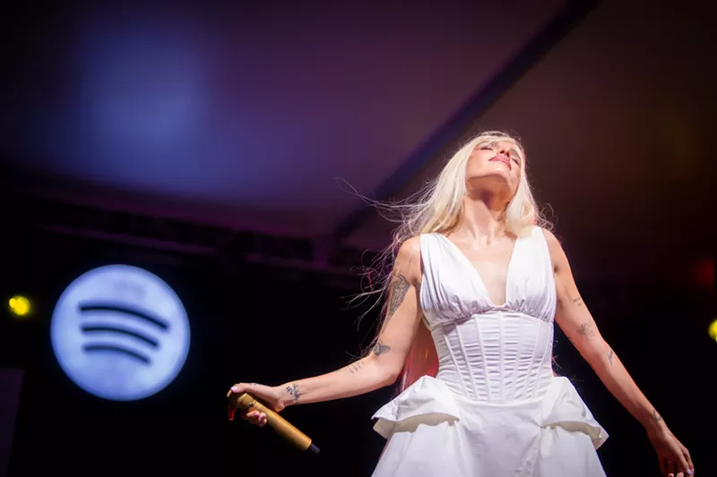 Image: Picture of singer Elena Rose on stage wearing a white dress.