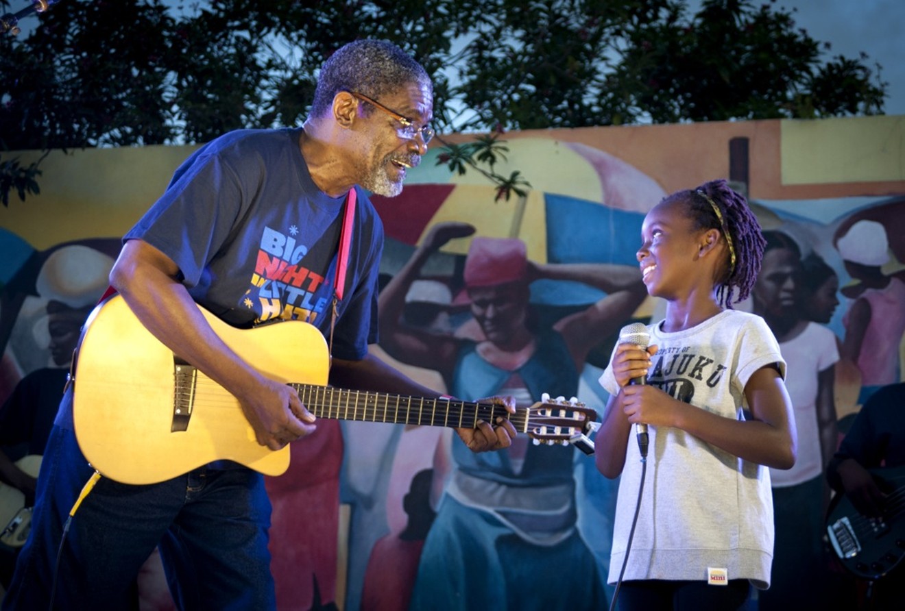 The late Haitian troubadour and former Port-au-Prince Mayor Manu Charlemagne shares the stage with a young fan at Big Night in Little Haiti.