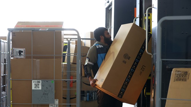 Amazon worker loading packages into delivery van