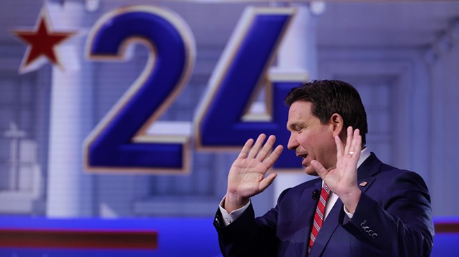 Florida Gov. Ron DeSantis raises his open hands during a town hall event in January 2024.