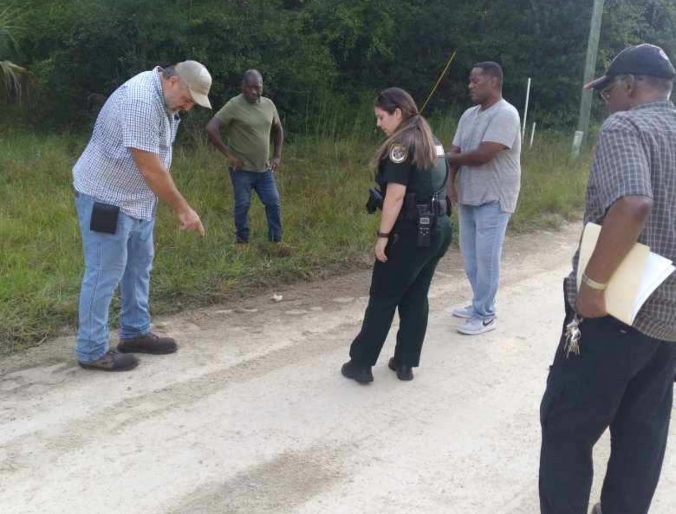 A Levy County Sheriff's deputy at the scene in Rosewood, Florida, where Marvin Dunn says a white neighbor attacked him and his group on September 6, 2022.
