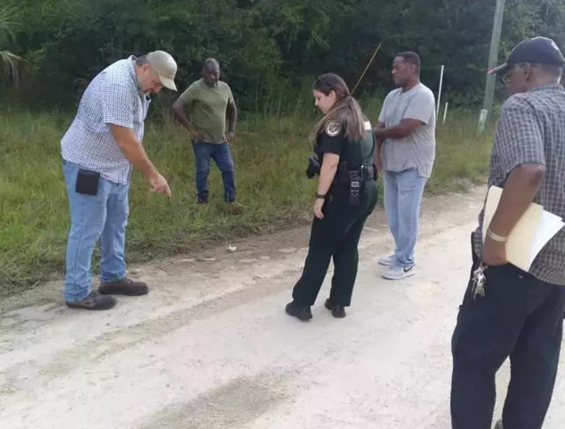 Image: A Levy County Sheriff's deputy at the scene in Rosewood, Florida, where Marvin Dunn says a white neighbor attacked him and his group on September 6, 2022.