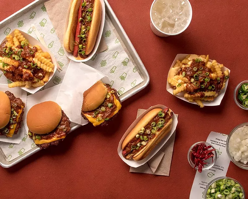 Image: Chili-topped burgers, fries, and dogs.