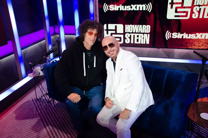 Image: Howard Stern and Pitbull at the SiriusXM Miami Studios
