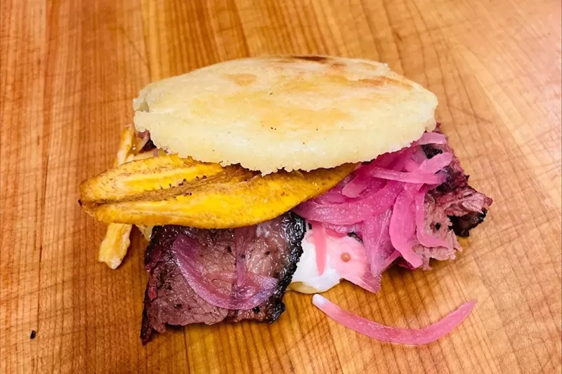 Image: Smoked brisket arepa with plantain chips and smoked Gouda, from Smoke & Dough in West Kendall