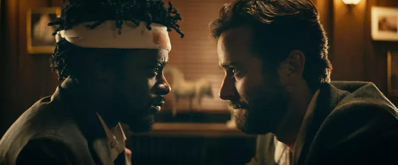 Image: Lakeith Stanfield (left) plays Cassius “Cash” Green and Armie Hammer is Steve Lift, a coke-sniffing imbecile rich boy, in Sorry to Bother You, Boots Riley’s profoundly hilarious directorial debut.
