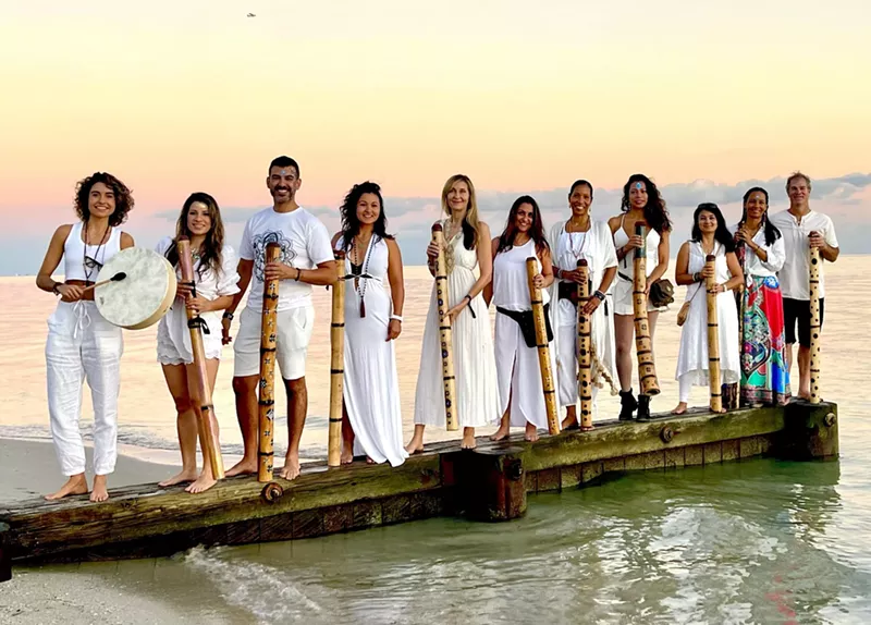 Image: The members of the South Beach Sound Healing Orchestra standing on a dock