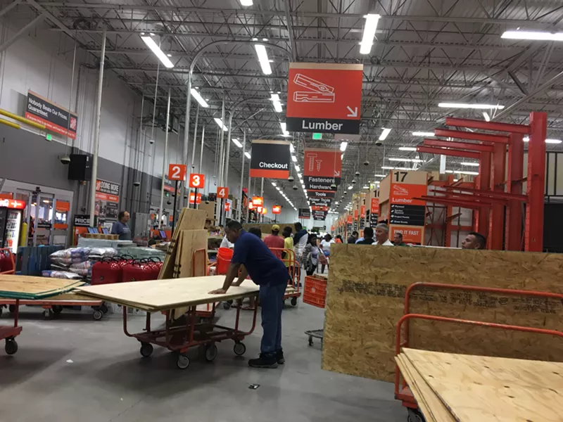 Image: People load up on plywood at a Fort Lauderdale Home Depot.