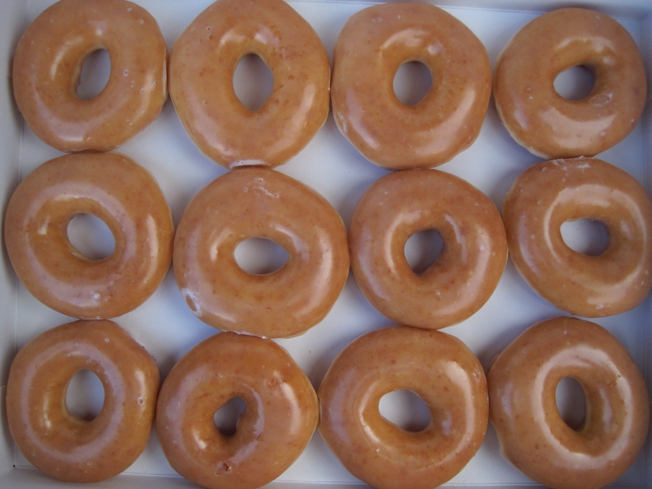 A dozen Krispy Kreme glazed doughnuts cost only 80 cents after you buy the first dozen at regular price.