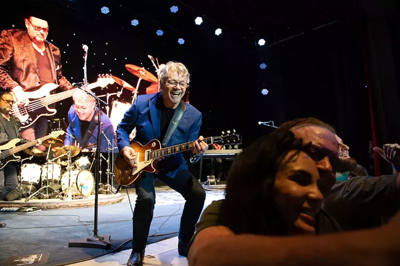 Image: Musician on stage playing guitar