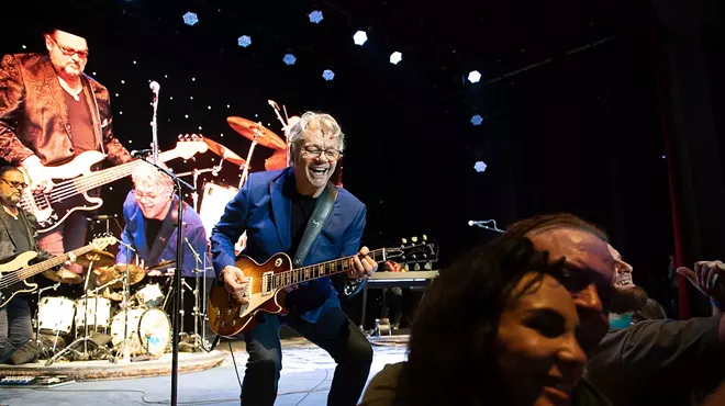 Musician on stage playing guitar