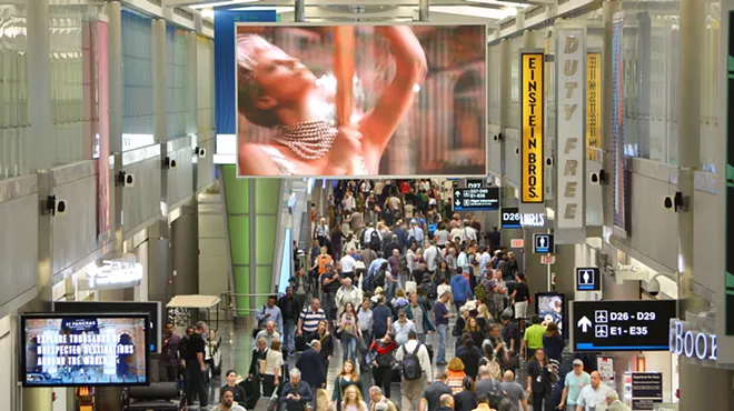 A crowded terminal at Miami International Airport (MIA) with passengers walking through Concourse D, showcasing the airport’s heavy traffic and growing demand