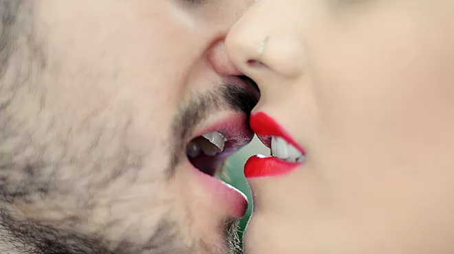 closeup of two people of a man and woman about to kiss