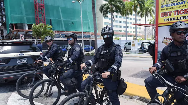 Miami Police Department bicycle officers stand ready at an anti-Trump protest.