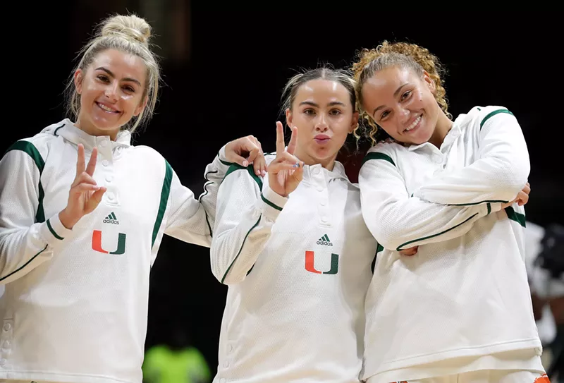 Image: Miami Hurricanes players Haley and Hanna Cavinder alongside Kenza Salgues gear up for a game against the Florida Atlantic Owls on November 16, 2022 in Coral Gables.
