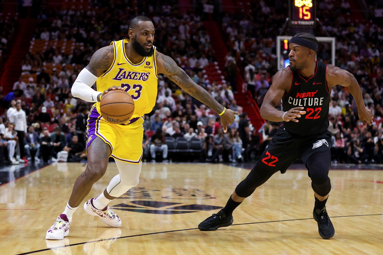LeBron James drives against Jimmy Butler during a game at Kaseya Center on November 6, 2023 in Miami, Florida.