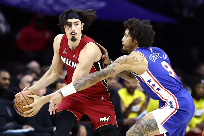 Image: Jaime Jaquez of the Miami Heat holds the basketball away from a Philadelphia 76ers reaching out for a steal