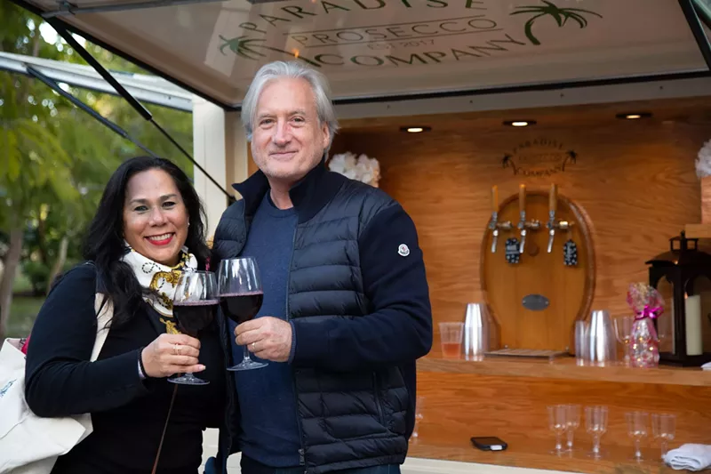 Image: A couple toasting with a glass of win