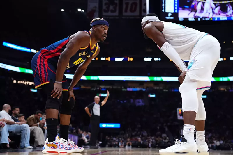 Image: Jimmy Butler III #10 of the Golden State Warriors and Bam Adebayo #13 of the Miami Heat on the court during the first quarter at Kaseya Center on March 25, 2025, in Miami, Florida.