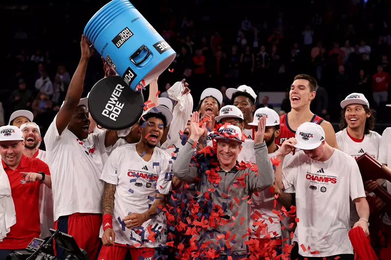 Image: Head coach Dusty May of the FAU Owls celebrates with the team after beating Kansas State in the NCAA Men's Basketball Tournament on March 25, 2023.