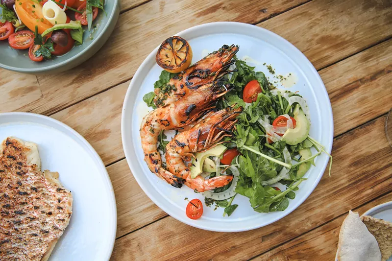 Image: Don't be fooled by simplicity — the quality of these whole wild prawns, grilled over wood with herbs and lemon, is outstanding.