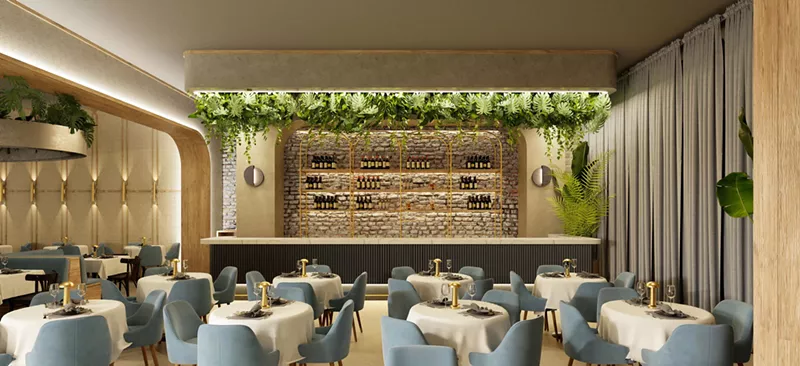 Image: A dining room and kitchen with greenery