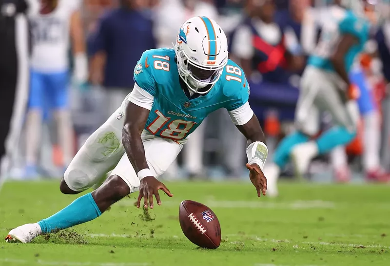 Image: MIAMI GARDENS, FLORIDA - SEPTEMBER 30: Tyler Huntley #18 of the Miami Dolphins recovers a fumble against the Tennessee Titans during the second quarter at Hard Rock Stadium on September 30, 2024 in Miami Gardens, Florida