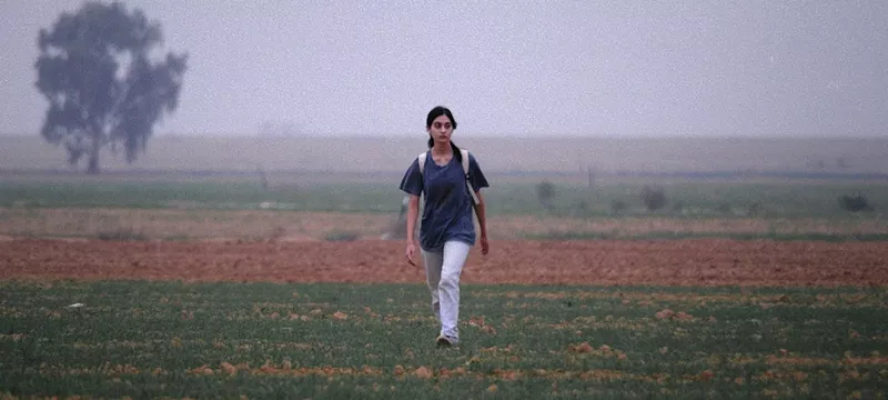 Image: man walking in a field