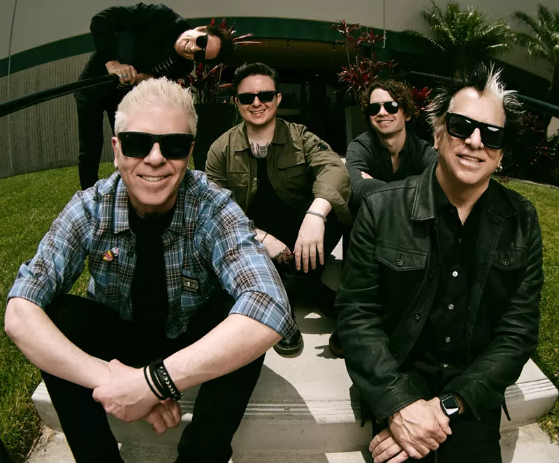 Image: Punk band the Offspring sitting on a staircase