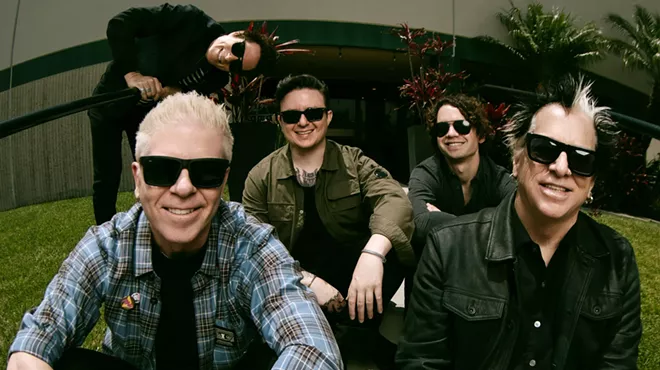 Punk band the Offspring sitting on a staircase