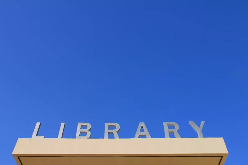 Image: graphically interesting photo of the LIBRARY sign above the entrance to the Miami Beach Regional Library at 227 22nd St.