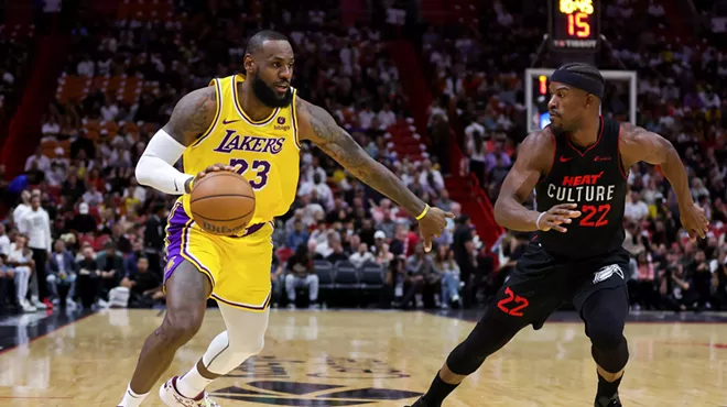 LeBron James looks to fend off Jimmy Butler in a game against the Miami Heat.